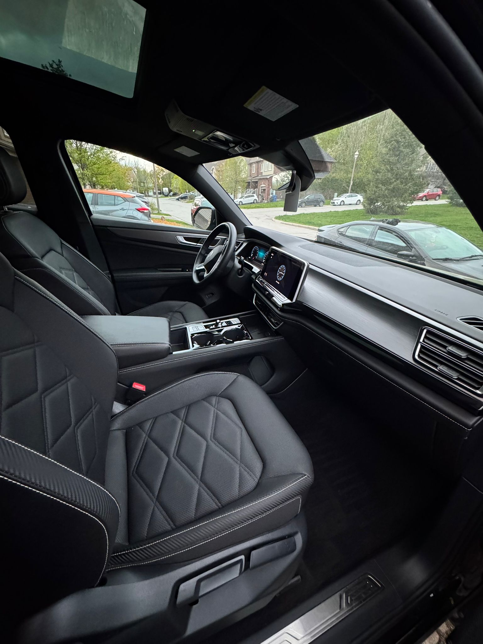 Freshly detailed luxury SUV interior with diamond-stitched leather seats and panoramic sunroof