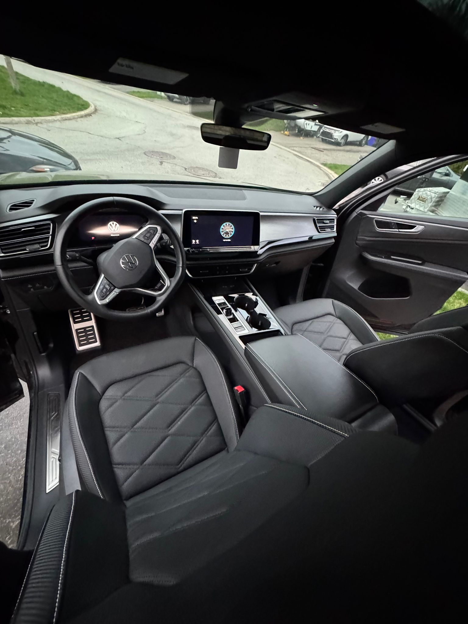 Detailed Volkswagen front cabin with clean dashboard and diamond-stitched seats